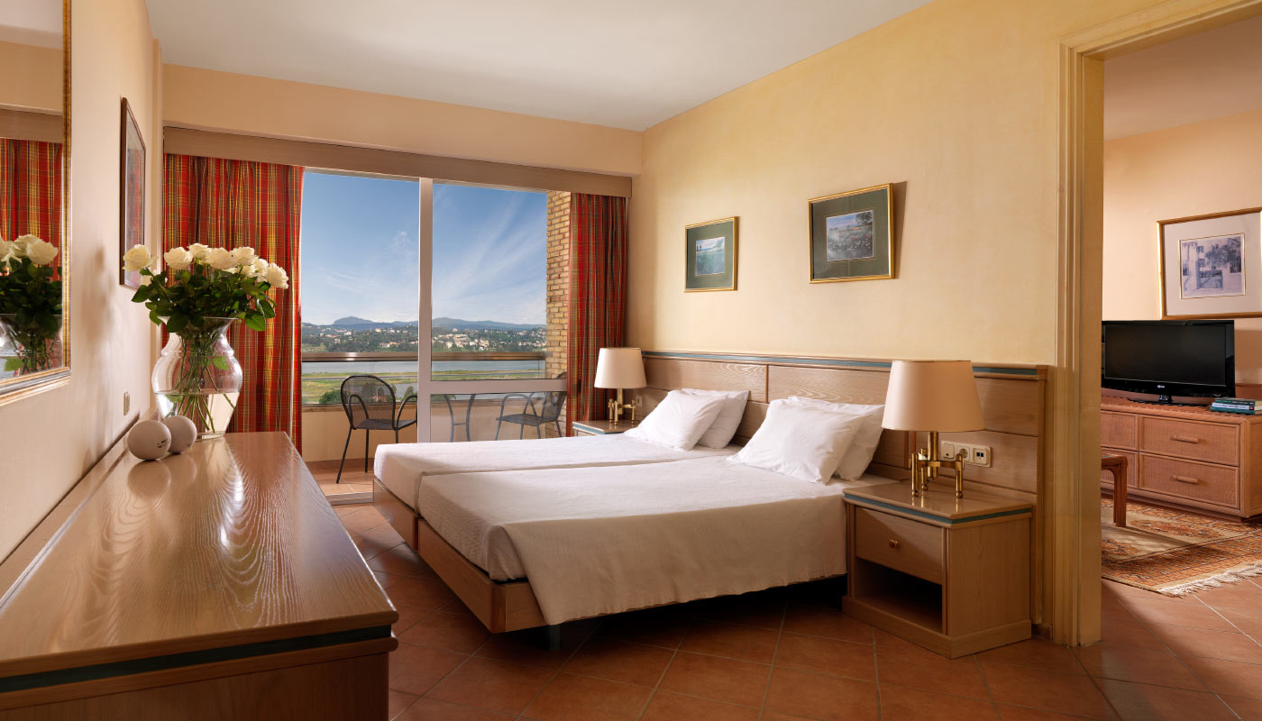 divani-corfu-palace-junior-suite-bedroom.jpg